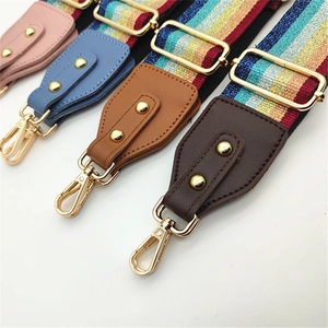 Detail showing various colorful PU leather bag strap ends with shiny gold metal hooks