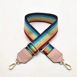 Detail of rainbow bag strap with gold metal hooks and pink faux leather ends