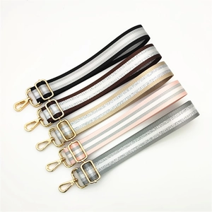 Adjustable crossbody handbag straps with shimmering silver stripes and gold hardware