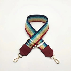 Adjustable rainbow striped bag strap with gold metal swivel hooks and red leather ends