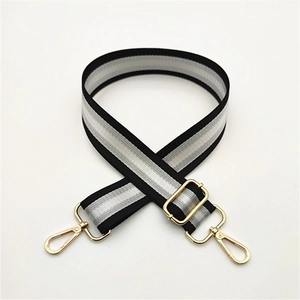 Close-up of adjustable striped replacement shoulder strap with gold metal lobster hooks