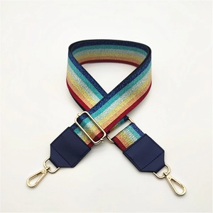 Adjustable rainbow striped bag strap with navy leather ends and gold metal buckles