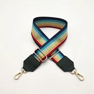 Detail view of adjustable rainbow glitter purse strap with gold metal lobster clasps
