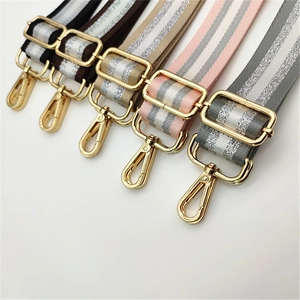 Detail of five colorful adjustable straps with metallic stripes and gold alloy buckles