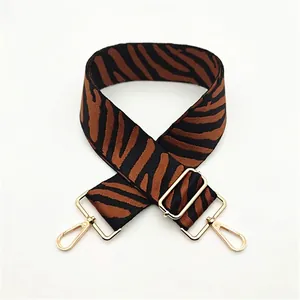 Adjustable wide replacement bag strap with brown zebra pattern and gold metal hardware