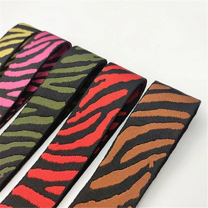 Detail view of colorful zebra pattern adjustable woven shoulder straps for handbags