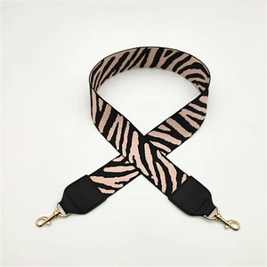 Detail of wide zebra print replacement bag strap with premium gold lobster clasps