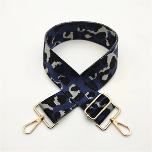 Adjustable wide leopard print bag strap with gold metal buckles and blue camouflage pattern