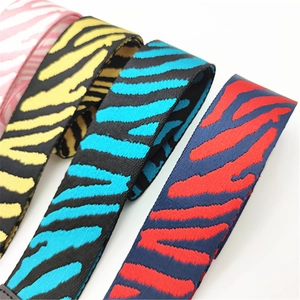 Close-up detail of adjustable wide zebra pattern bag straps in multiple color variations