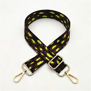Detail of leopard print bag strap in brown and lime green with gold metal clips