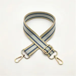 Adjustable woven strap for bags with blue and beige stripes and gold metal hooks