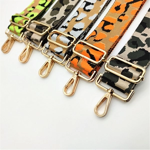 Detailed view of five colorful leopard print woven replacement straps with gold buckles