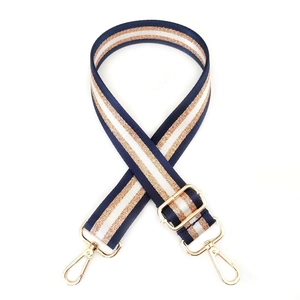 Detail of adjustable polyester bag strap with shiny gold thread and metal lobster clasps
