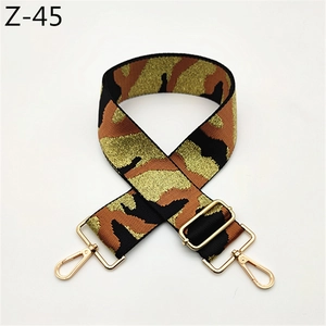 Detail of camouflaged adjustable wide strap with metallic gold thread and swivel hooks