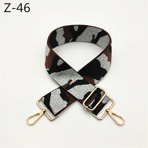 Detail of adjustable camouflage pattern shoulder strap with golden metal lobster clasps
