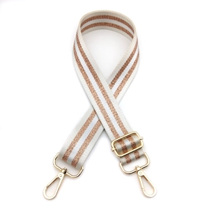 Detail of white strap with rose gold sequins, golden metal buckle and lobster clasps