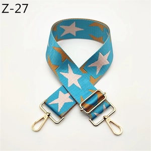 Detail of blue guitar strap with star patterns and adjustable golden metal buckles