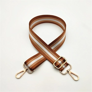 Detail of adjustable three-color woven shoulder strap with gold metal lobster clasps