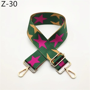 Detail of adjustable star print canvas strap with golden metal lobster clasps