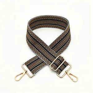 Detail of widened geometric twill pattern shoulder strap with golden metal lobster hooks