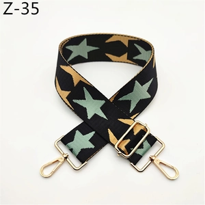 Detail of adjustable star pattern shoulder strap with golden metal swivel hooks