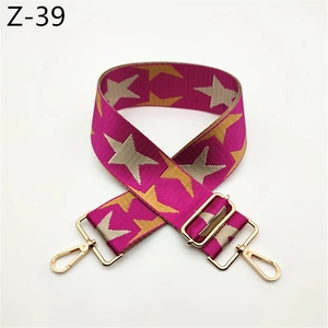 Detail of adjustable star pattern shoulder strap with golden metal lobster clasps