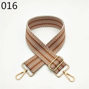 Detail of adjustable brown geometric herringbone wide shoulder strap with gold metal hooks