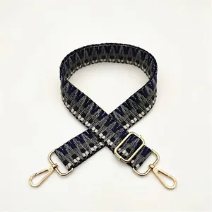 Close-up of geometric woven replacement bag strap No. 53 with golden metal buckles