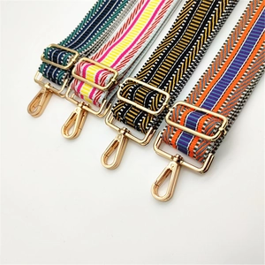 Detail of four colorful patterned wide bag straps with adjustable gold metal hardware buckles