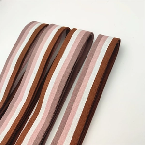 Detailed macro view of woven nylon strap featuring brown pink and white stripes texture