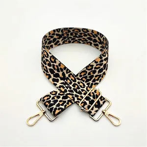 Detail of adjustable leopard print bag strap with polished light gold metal hooks