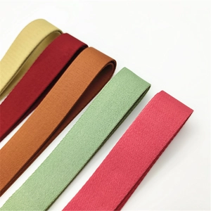 Close-up of adjustable thick fabric bag straps in mustard yellow burgundy and green