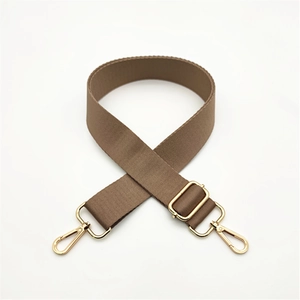 Close-up of brown nylon bag strap with high-density texture and gold metal hooks