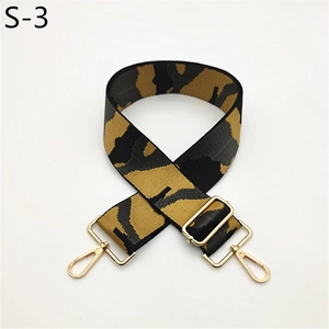 Close-up of camouflage wide bag strap with golden metal lobster clasps and buckle