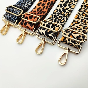 Detail showing four assorted leopard print replacement bag straps with gold metal buckles