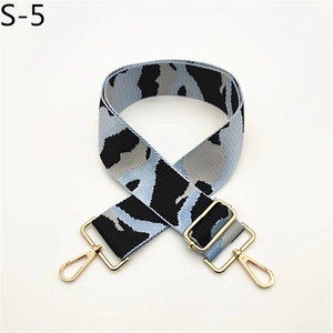 Macro shot of wide camo strap with blue leopard jacquard fabric and golden metal hooks
