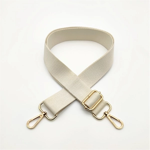 Detail view of thickened adjustable beige canvas shoulder strap with gold metal hooks