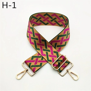 Detail of green and purple woven wide shoulder strap with gold metal adjustment buckle