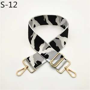 Detail of adjustable black and grey camo bag strap with premium gold hardware hooks