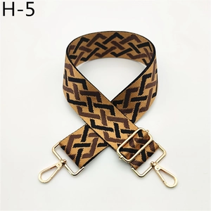 Close-up of adjustable woven shoulder strap with geometric wave pattern and gold hooks