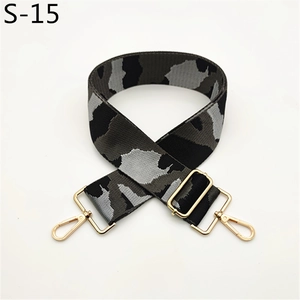 Detail of adjustable wide camo bag strap with durable fabric and gold swivel hooks