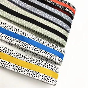 Close-up of colorful adjustable wide shoulder straps with pixelated dotted weave patterns