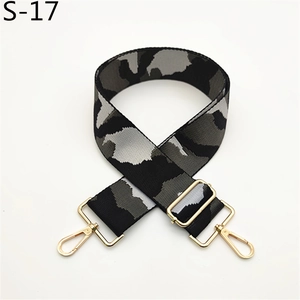 Detail view of adjustable black and grey camo nylon strap with golden metal lobster hooks