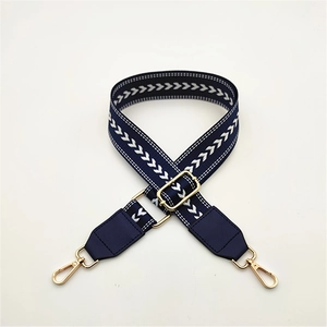 Adjustable navy herringbone strap with white V-pattern and gold metal swivel hooks