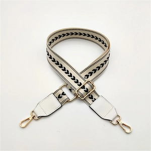 Adjustable black and white arrow pattern woven bag strap with white leather and gold clips
