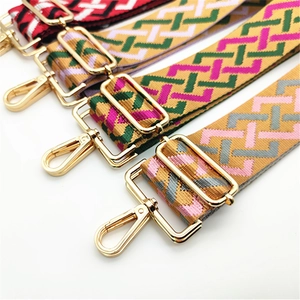 Detail of four colorful geometric jacquard bag straps with shiny gold metal lobster clasps