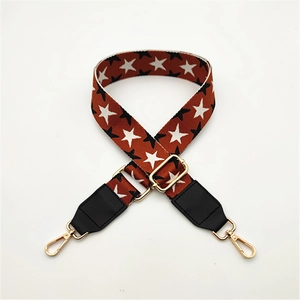 Detail of adjustable star pattern shoulder strap with golden metal swivel hooks