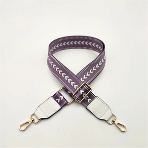 Adjustable purple nylon handbag strap with white V-shaped pattern and gold metal hooks