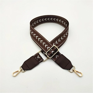 Adjustable brown woven shoulder strap with white chevron pattern and gold metal buckles