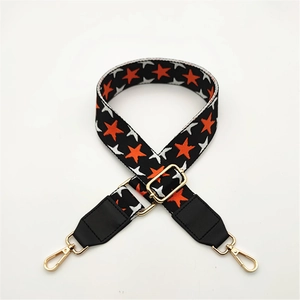 Adjustable woven shoulder strap with orange and silver stars and golden metal buckles